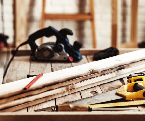 Hand saw on a wooden table in carpentry workshop